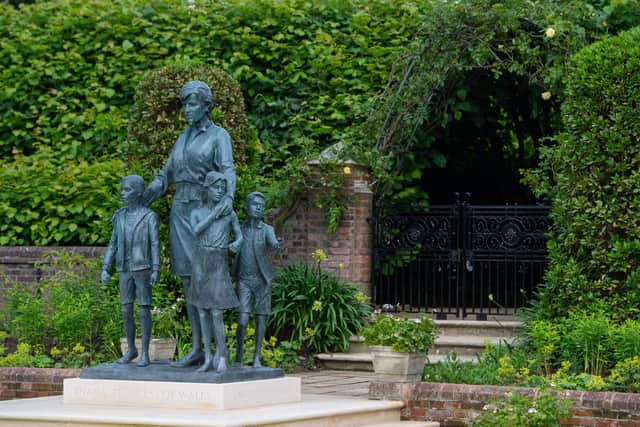 The bronze statue depicts the princess surrounded by three children to represent the "universality and generational impact" of her work (Getty)