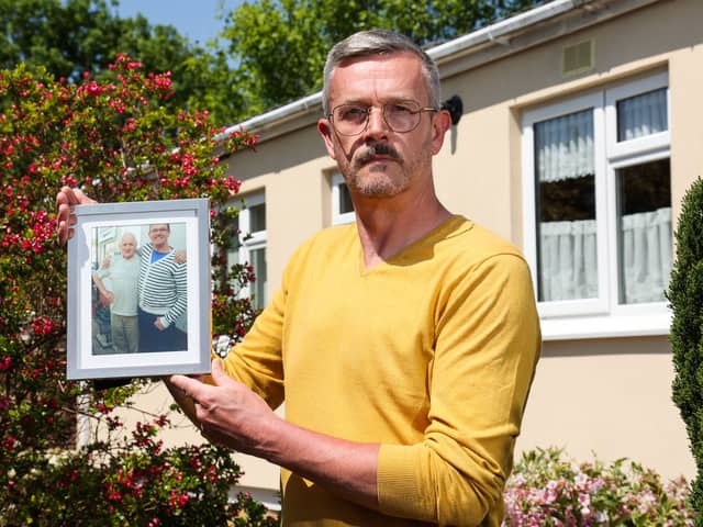 Leigh Blanning with a photo of his late father, John.