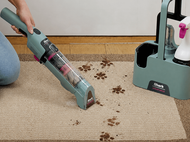 The cordless Shark StainForce comes with a storage caddy, two attachments and two 500ml bottles of cleaning solution