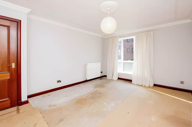 The bright and spacious lounge forms the main reception area of this one-bedroom home