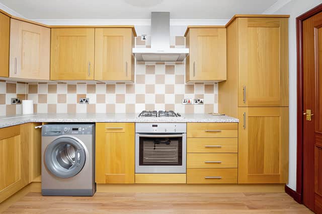 A modern fully fitted kitchen provides wall and base units as part of the flat's practical layout
