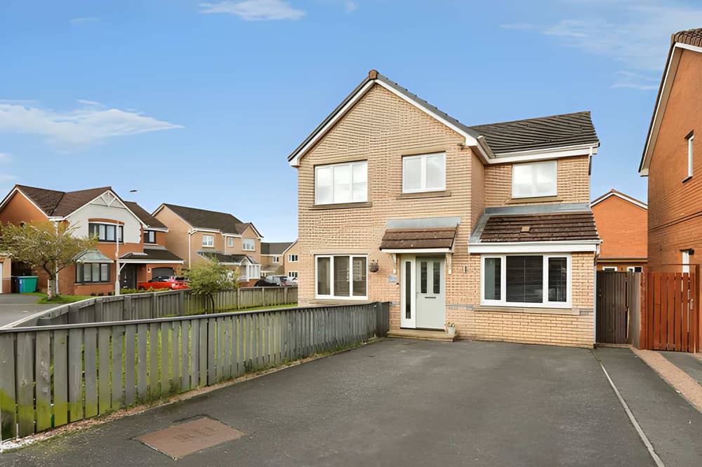 Back on the market for £299,995, this detached Dunfermline house has a large tarred driveway and a garden that extends around to the rear