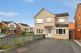 Back on the market for £299,995, this detached Dunfermline house has a large tarred driveway and a garden that extends around to the rear