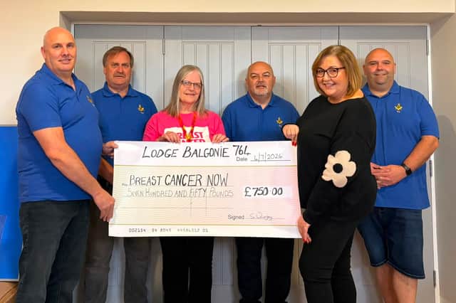 Presentation of cheque by Lorna Rougvie to Blue White of Breast Cancer Now.