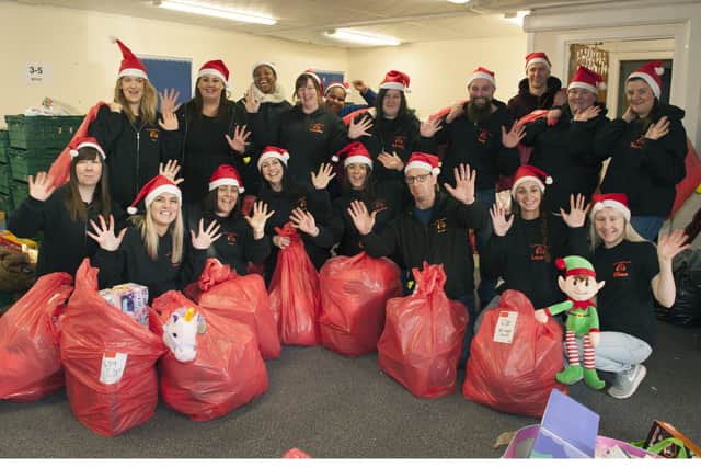 Staff and Volunteers from the Cottage family Centre make up Christmas sacks.