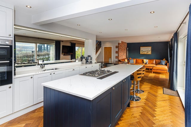 A central work island doubles as a breakfast bar within the high spec kitchen.