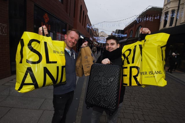 Liam Williams and Matt Green, right, with their bagged bargains.