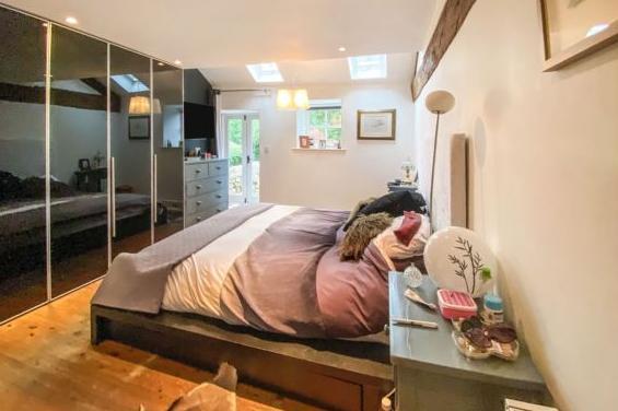 The master bedroom is located on the ground floor and has a wooden flooring, exposed beams and has lots of natural light due to the rear two roof windows.