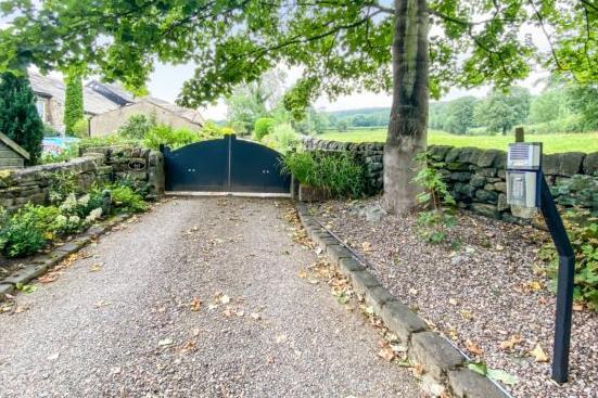 Outside, the property is accessed by a private driveway.