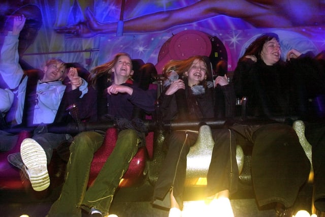 Youngsters celebrate New Years Eve on a fairground ride in Millennium Square on December 31, 2002.