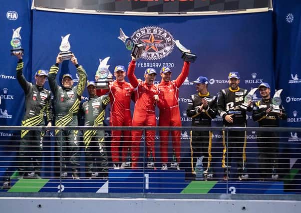 Jonny Adam (centre right in red) on the podium at Circuit of the Americas.
