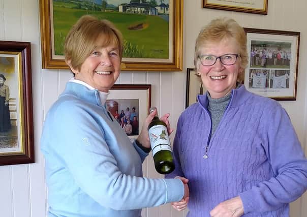 Captain Senga Hogg presented Linda Mould with a bottle of wine on her hole in one on Friday 13 March
