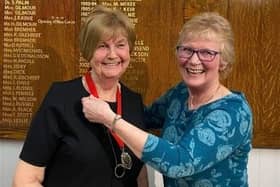 Retiring captain Linda Mould presented new captain Senga Hogg with the chain of office at the AGM on March 11