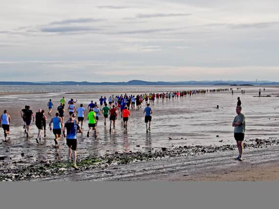 Runners head out across Pettycur Sands during a previous Black Rock 5 race. Pic: Glyn Ednie