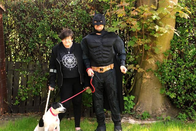 Mark has been doing his daily walk dressed as Batman, and cheering up the local children during lockdown.  He's pictured with fiancee Tricia and dog Star.  Pic: Fife Photo Agency