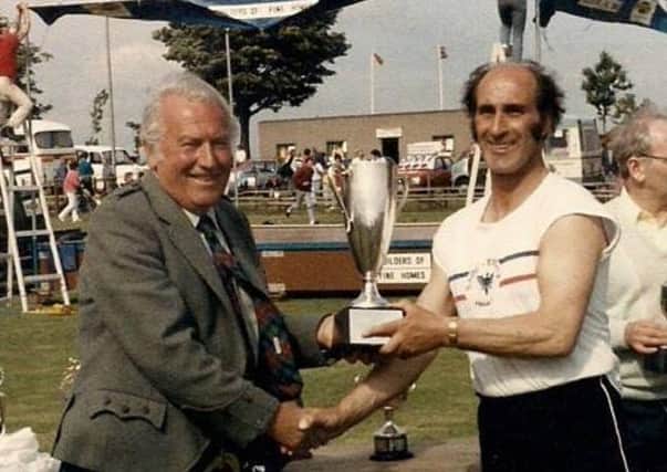 Sir George Sharp presents 1984 200 metres winner Joe Baird with his prize
