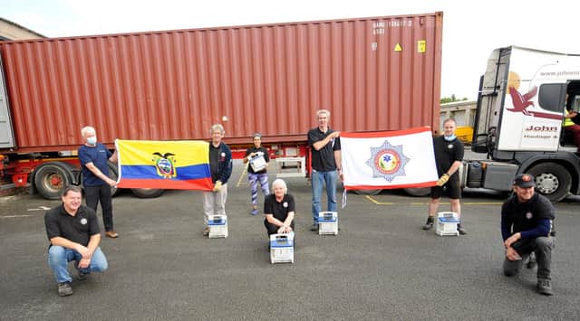 Volunteers from the International Fire & Rescue Association fill a ship container bound for Ecuador with hospital equipment.  Pic: Fife Photo Agency