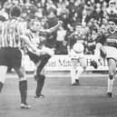 Raith's Peter Hetherston and Dunfermline's Craig Robertson challenge for the ball.