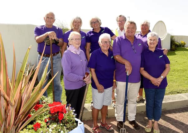 Alice Soper and Judith Kerr of Growing Kirkcaldy with fellow members of Growing Kirkcaldy on the prom at one of the planters which had plants stolen. Pic: Fife Photo Agency.