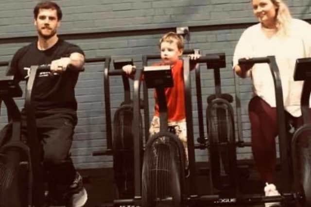 Sam and Huw with their son Clark. They are the owners of Strength Lab Crossfit in Kirkcaldy.