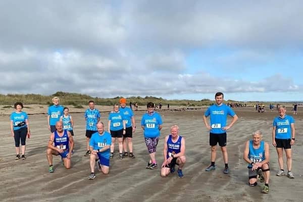 Socially distanced Falkland Trail Runners on the West Sands prior to taking part in the Chilly Willy Beach Race.