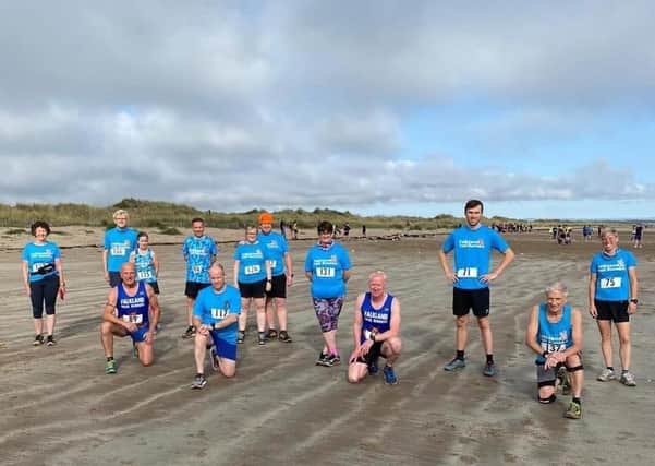 Socially distanced Falkland Trail Runners on the West Sands prior to taking part in the Chilly Willy Beach Race.