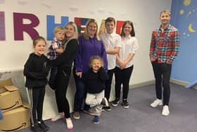 STV weatherman Sean Batty with Caz Morrison and her family on his visit to Muirhead Outreach Project