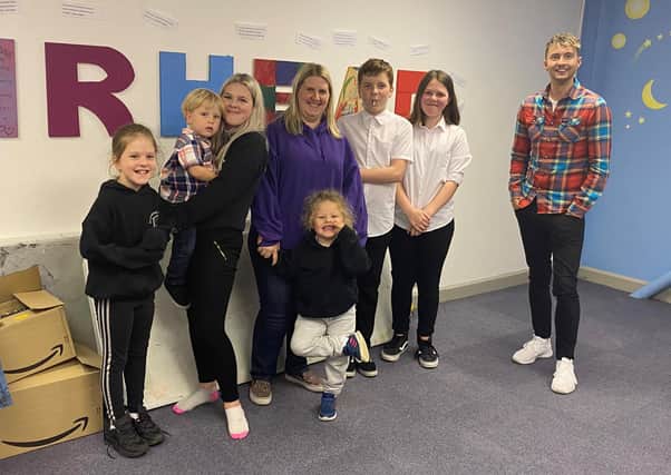 STV weatherman Sean Batty with Caz Morrison and her family on his visit to Muirhead Outreach Project