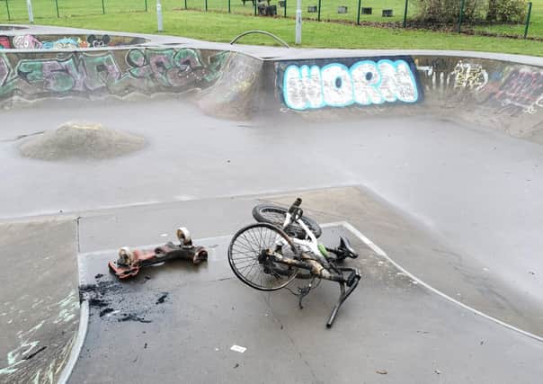 A burned out scooter and bike at the skate park.
