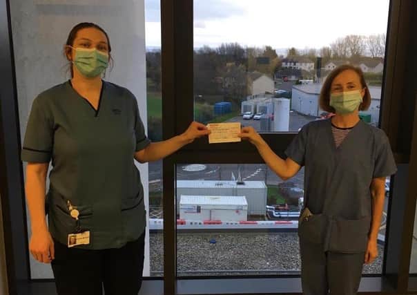 Pamela Cruickshanks donating the cheque to the haematology ward.