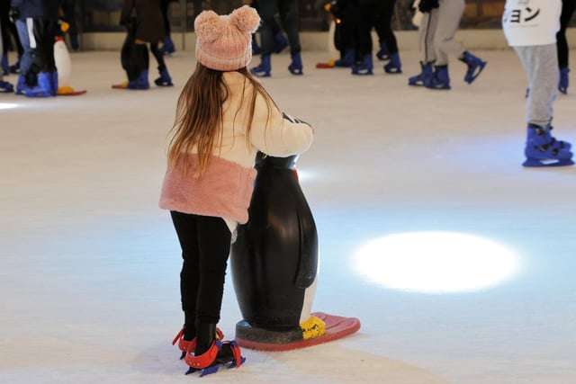 A child enjoying the ice rink with a skate assistant penguin. Picture by Neil Cooper.