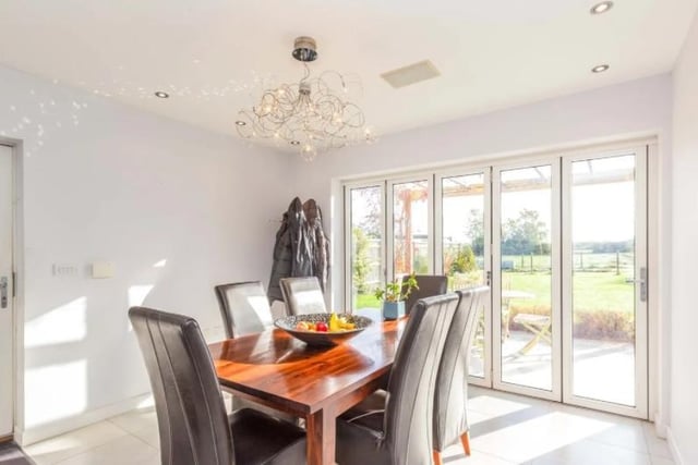 The dining room which boasts full width bi-fold doors opening onto large patio and vast garden.