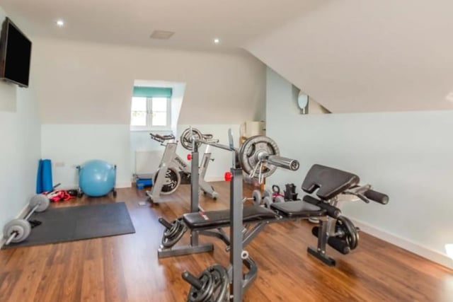 The home gym in the large luxurious home, it allows you to watch the telly while logging miles on the bike.