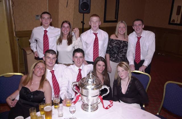 Derry City players Kevin Deery, Gareth Mullan, Gary Ramsey (back row), Darren McCready and Gareth McGlynn (front row) celebrate their 2002 FAI Cup win over Shamrock Rovers with friends.