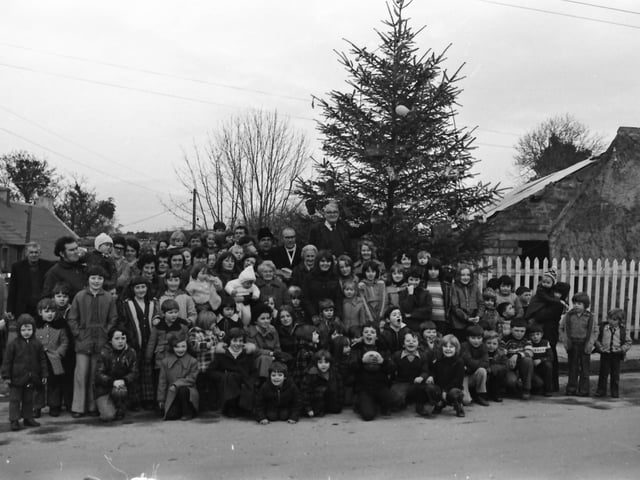 George Dunne, secretary of St. Johnton Improvements Committee, switching on the town’s Christmas lights. Included are John Duffy, Rev. W. Hanna, Very Rev. Dr. D. Cuinnea, Nellie McDaid and Winnie McCracken, members of the committee.