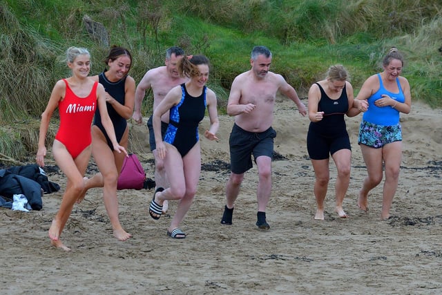 Enthusiastic swimmers run towards Lough Swill during the annual Christmas Day swim at Ludden beach, Buncrana. Photo: George Sweeney.  DER2151GS – 015
