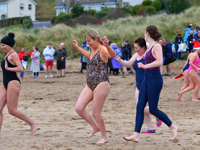 Swimmers make their way to the sea at the annual Christmas Day swim at Ludden beach, Buncrana. Photo: George Sweeney. DER2151GS – 024