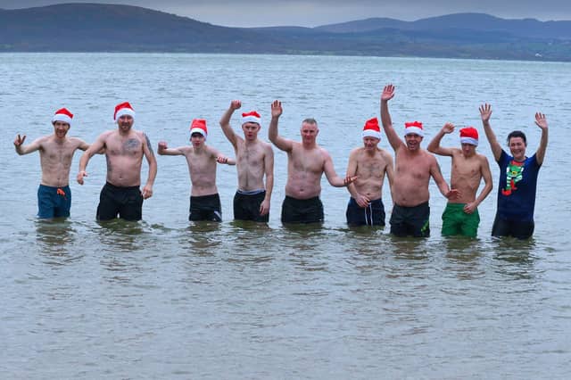 Some of the many swimmers who raised funds for charities at the annual Christmas Day swim at Ludden beach, Buncrana. Photo: George Sweeney. DER2151GS – 027