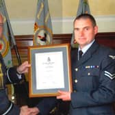 Brian (right) receiving an accommodation from his time in the RAF.