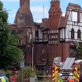 Fire crews remained at the charred Lundin Links Hotel today