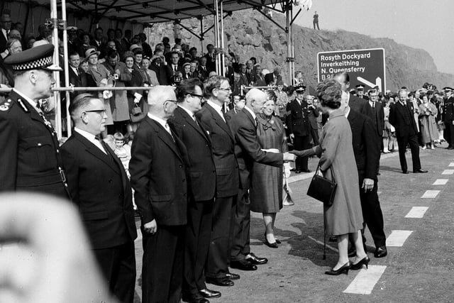 Queen Elizabeth II shakes hands with Sheriff Lillie in Fife,  when she officially opens the Forth Road bridge in September 1964.
