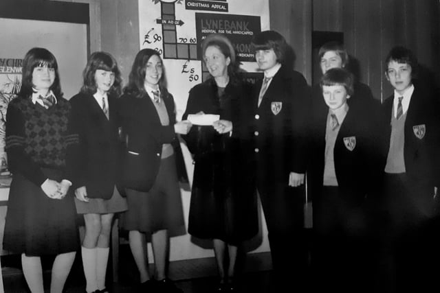 Pupils from Glenwood High School in Glenrothes pictured in 1975 making a domination to Lynebank Hospital in Dunfermline.