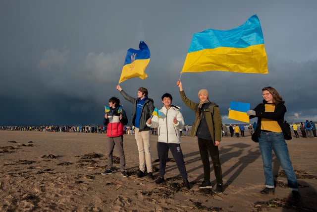 St Andrews University students show their support by flying the flag of Ukraine at the protest against the war held on the West Sands.