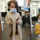 Rachel Shaw at Alison Stewart Hairdressing Salon, and showing off the hair which she has donated.