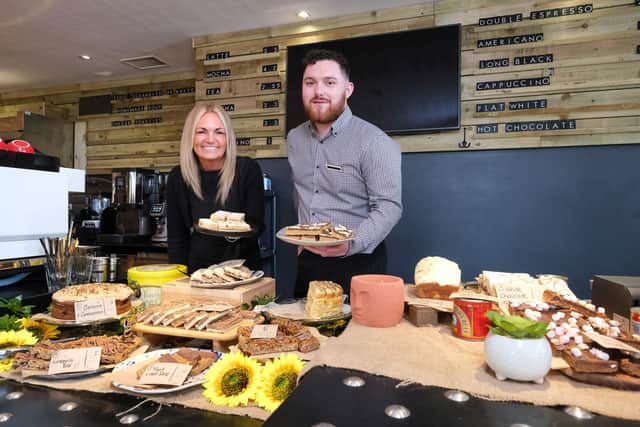 Tracy McCafferty, Venue Manager at Dunfermline Carnegie Library & Galleries, and Kieran Conner, OWI business development manager, with some of the tasty offerings now being served up in The Granary.