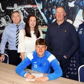 Aaron Arnott signs for Raith Rovers with vice chairman Steve MacDonald, mum and dad Emma and Derek, and assistant manager Paul Smith. (Pic: Tony Fimister)