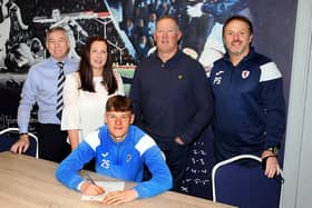 Aaron Arnott signs for Raith Rovers with vice chairman Steve MacDonald, mum and dad Emma and Derek, and assistant manager Paul Smith. (Pic: Tony Fimister)