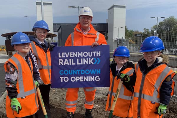 David Torrance, MSP for Kirkcaldy, with Methilhill Primary pupils Lily Wren (P1); Riley Semple (P2); Dawid Rzepka (P5) and Sophia Ballon (P7) burying the school's time capsule at the new Cameron Bridge station.  (Pic: Network Rail)