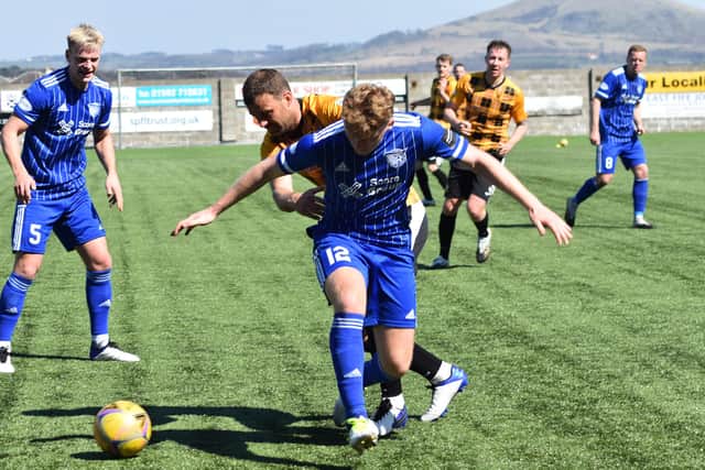 Kevin Smith wins possession back from Peterhead's Andrew McCarthy