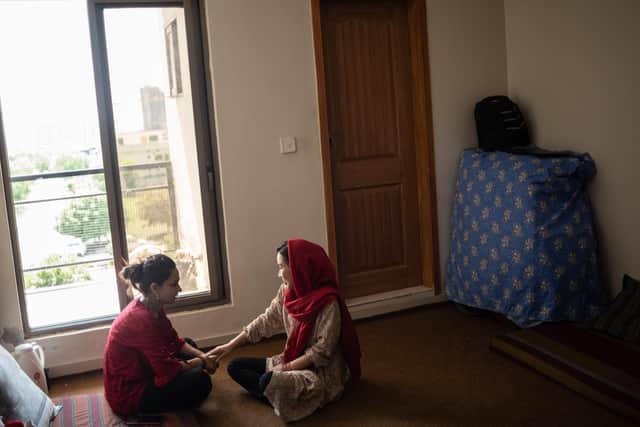 A efugee talks with her roommate at a guesthouse run by the Future Brilliance charity (Photo by Rebecca Conway/Getty Images)